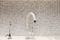 Modern designer chrome water tap over stainless steel kitchen sink. Interior of bright white kitchenÃÅ½ Royalty Free Stock Photo