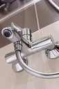 Modern designer tap and shower in bathroom. Royalty Free Stock Photo