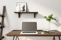 Modern designer workplace with laptop on wooden table
