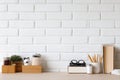 Minimalist Desk Setup with White Brick Wall Backdrop Royalty Free Stock Photo