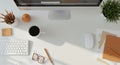 Modern desk setup with a large computer monitor displaying a webpage, Royalty Free Stock Photo