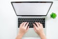 Modern desks have the hands of women using a laptop computer. Top view