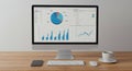 Modern Desktop Computer Displaying Business Analytics Charts and Graphs in a Minimalist Office Setting Royalty Free Stock Photo