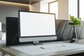 Modern desktop computer setup with plants on office desk, elegant work environment.