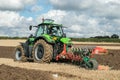 Modern deutz fahr tractor pulling a plough