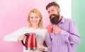 Modern devices make our life easier. Spending good morning together. Couple prepare morning drink electric kettle device Royalty Free Stock Photo