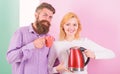 Modern devices make our life easier. Spending good morning together. Couple prepare morning drink electric kettle device Royalty Free Stock Photo