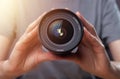 Modern digital camera wide-angled 35 mm lens in hands of woman, closeup