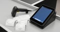 Modern digital cash register with receipts and barcode scanner on a store counter. concept of retail technology, payment Royalty Free Stock Photo
