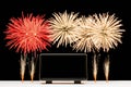 A modern digital clock displaying midnight while fireworks illuminate the night sky during a celebration Royalty Free Stock Photo