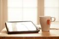 Modern Digital Devices on Wooden Table, Blurred windows background, Digital Tablet, Tea and Newspaper