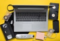 Modern digital gadgets, storage media, devaysy and obsolete analog media devices on a yellow paper background. Top view. Flat lay