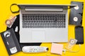 Modern digital gadgets, storage media, devaysy and obsolete analog media devices on a yellow paper background. Top view. Flat lay.