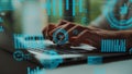 Modern Digital Interface with Graphs and Data Analytics Overlaying a Person Hands Typing on a Laptop Keyboard in a Royalty Free Stock Photo