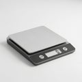 A modern digital kitchen scale with a stainless steel platform on a white background digital scale Royalty Free Stock Photo