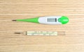 Modern digital and mercury thermometers on table, flat lay