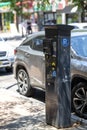 Modern Digital Parking Meter Station on a Busy City Street During Daytime