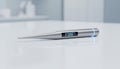 A modern digital thermometer on a clean surface symbolizing contemporary healthcare technology Royalty Free Stock Photo