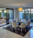 Modern dining room with eight chairs next to outdoor alfresco sitting area