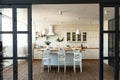 Modern dining room and kitchen interior with table and chairs, big window and wooden floor. Home decor, interior design Royalty Free Stock Photo