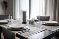 modern dining room with sleek, minimalist table linens and silver flatware Royalty Free Stock Photo