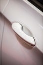 Modern door handle of a white car Royalty Free Stock Photo