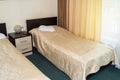 Modern double room with two single beds, bedside table, towels and table lamp, cozy inexpensive room for travelers, good service