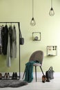 Modern dressing room interior with clothing rack and chair Royalty Free Stock Photo