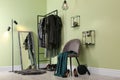 Modern dressing room interior with clothing rack, chair and mirror Royalty Free Stock Photo