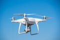 The modern drone, quadrocopter is in the air against the background of the sky and grass Royalty Free Stock Photo