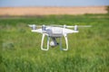 The modern drone, quadrocopter is in the air against the background of the sky and grass Royalty Free Stock Photo