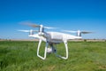 The modern drone, quadrocopter is in the air against the background of the sky and grass Royalty Free Stock Photo