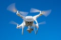 The modern drone, quadrocopter is in the air against the background of the sky and grass Royalty Free Stock Photo