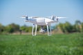 The modern drone, quadrocopter is in the air against the background of the sky and grass Royalty Free Stock Photo