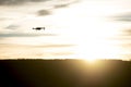 Modern drone silhouetted against sunset Royalty Free Stock Photo