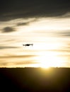 Modern drone silhouetted against sunset Royalty Free Stock Photo