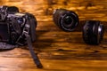 Modern dslr camera and lenses on wooden table Royalty Free Stock Photo