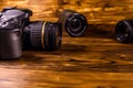 Modern dslr camera and lenses on wooden table Royalty Free Stock Photo