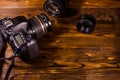 Modern dslr camera and lenses on wooden table Royalty Free Stock Photo