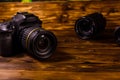 Modern dslr camera and lenses on wooden table Royalty Free Stock Photo