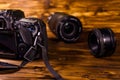 Modern dslr camera and lenses on wooden table Royalty Free Stock Photo