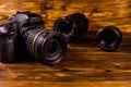 Modern dslr camera and lenses on wooden table Royalty Free Stock Photo