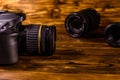 Modern dslr camera and lenses on wooden table Royalty Free Stock Photo