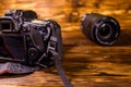 Modern dslr camera and lenses on wooden table Royalty Free Stock Photo