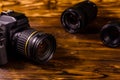 Modern dslr camera and lenses on wooden table Royalty Free Stock Photo