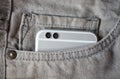 Modern dual camera smart phone in jeans pocket Royalty Free Stock Photo