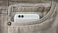 Modern dual camera smart phone in jeans pocket Royalty Free Stock Photo