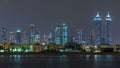 Modern Dubai city skyline timelapse at night with illuminated skyscrapers over water surface Royalty Free Stock Photo