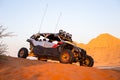 Modern dune buggy parked on sand in the desert with mountains in the background. Royalty Free Stock Photo