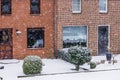 Modern dutch terraced houses with a garden during a cold winter day, snowy weather in a small village of the Netherlands Royalty Free Stock Photo